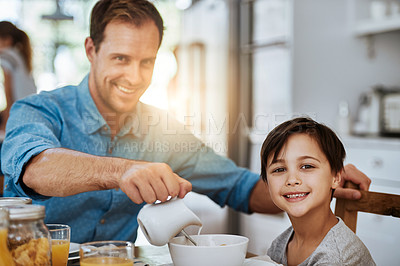 Buy stock photo Portrait of a father and his little son having breakfast together at home