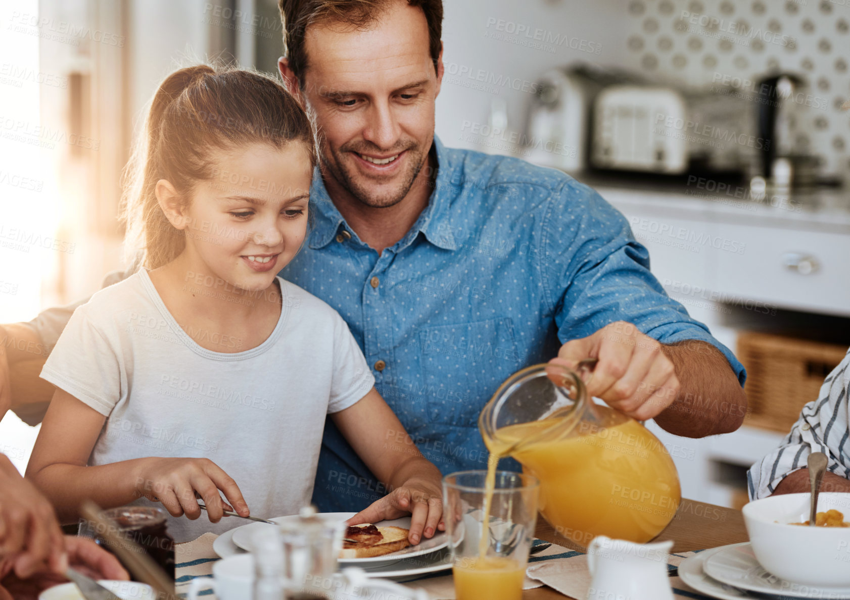 Buy stock photo Cropped shot of a father and his little daughter having breakfast together at home