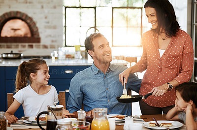 Buy stock photo Cropped shot of a family enjoying breakfast together at home