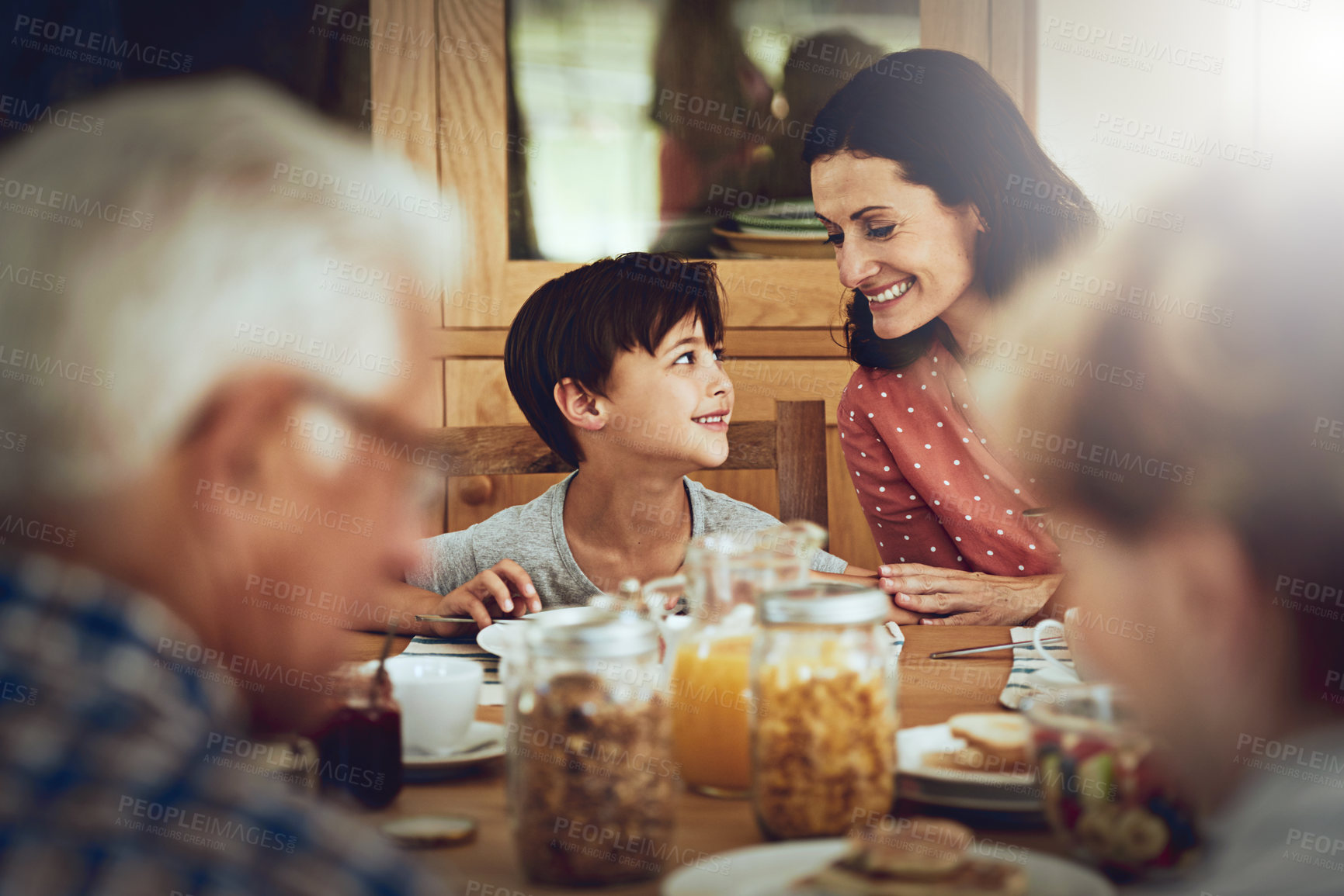 Buy stock photo Cropped shot of a family enjoying breakfast together at home