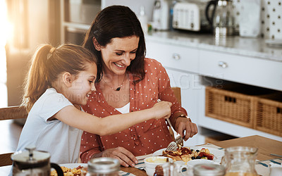 Buy stock photo Cropped shot of a mother and her little daughter having breakfast together at home