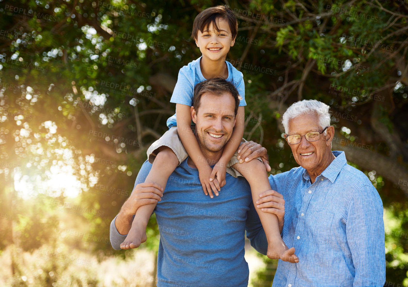 Buy stock photo Portrait of a cute boy posing outside with his father and grandfather