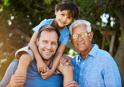 Buy stock photo Portrait of a cute boy posing outside with his father and grandfather
