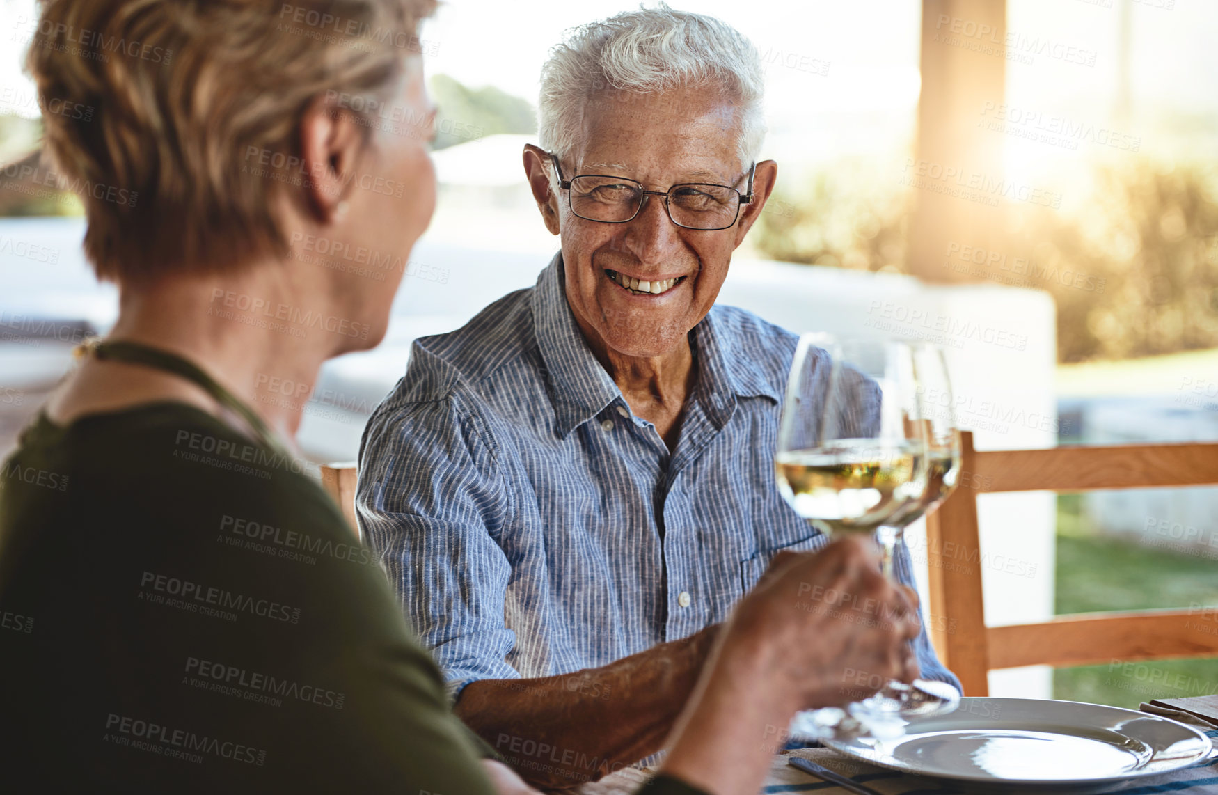 Buy stock photo Shot of a happy mature couple enjoying lunch together outside