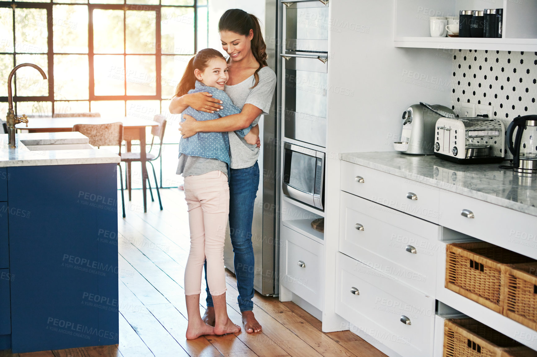 Buy stock photo Portrait of a happy mother and daughter in a loving embrace at home