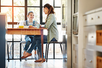 Buy stock photo Shot of a happy mother and daughter enjoying breakfast together at home