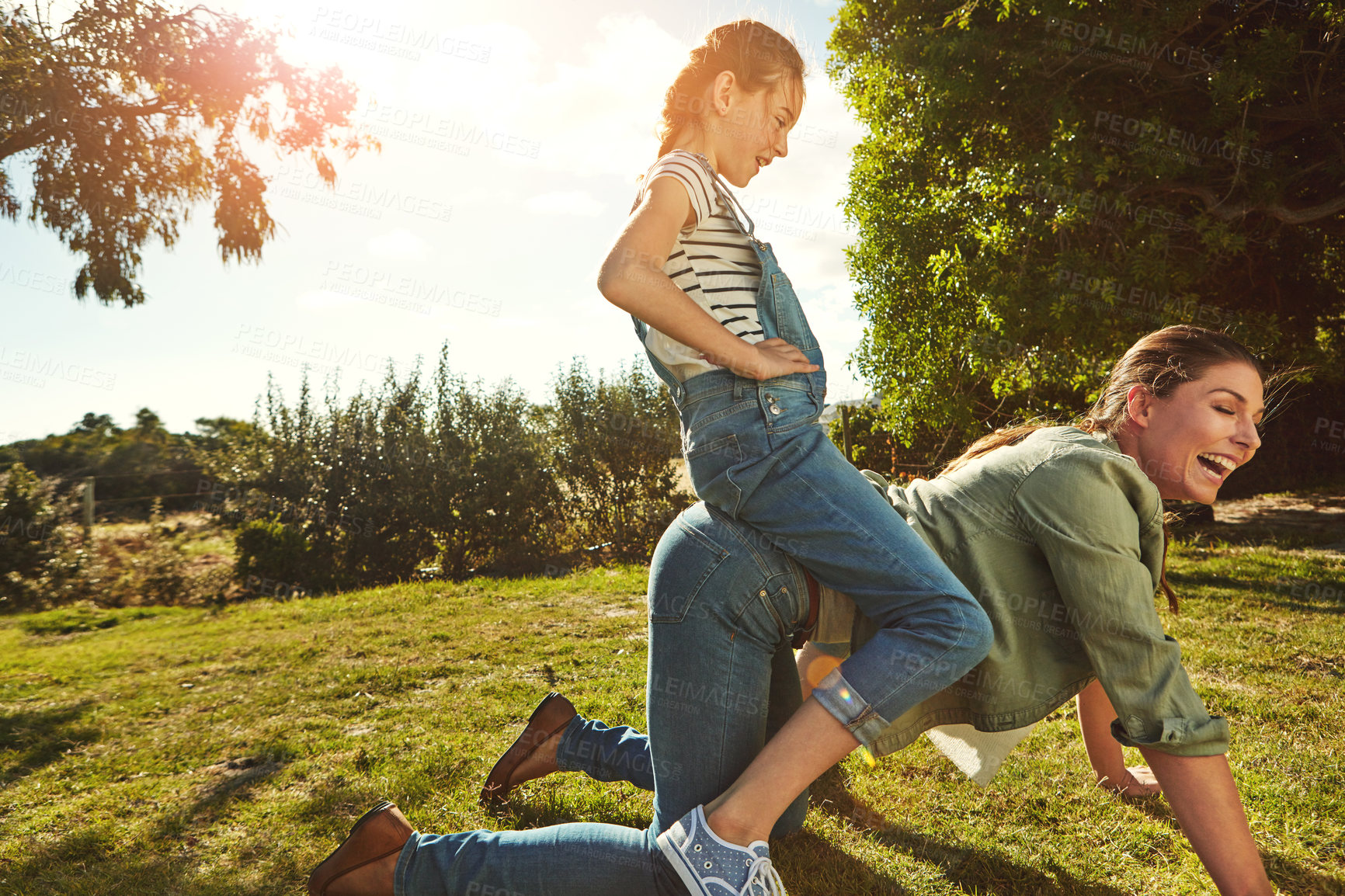 Buy stock photo Mother, child and piggy back in nature with happy family, fun and playing in park with blue sky for bonding or love. Summer, caring and attachment on relax holiday together, girl daughter and weekend