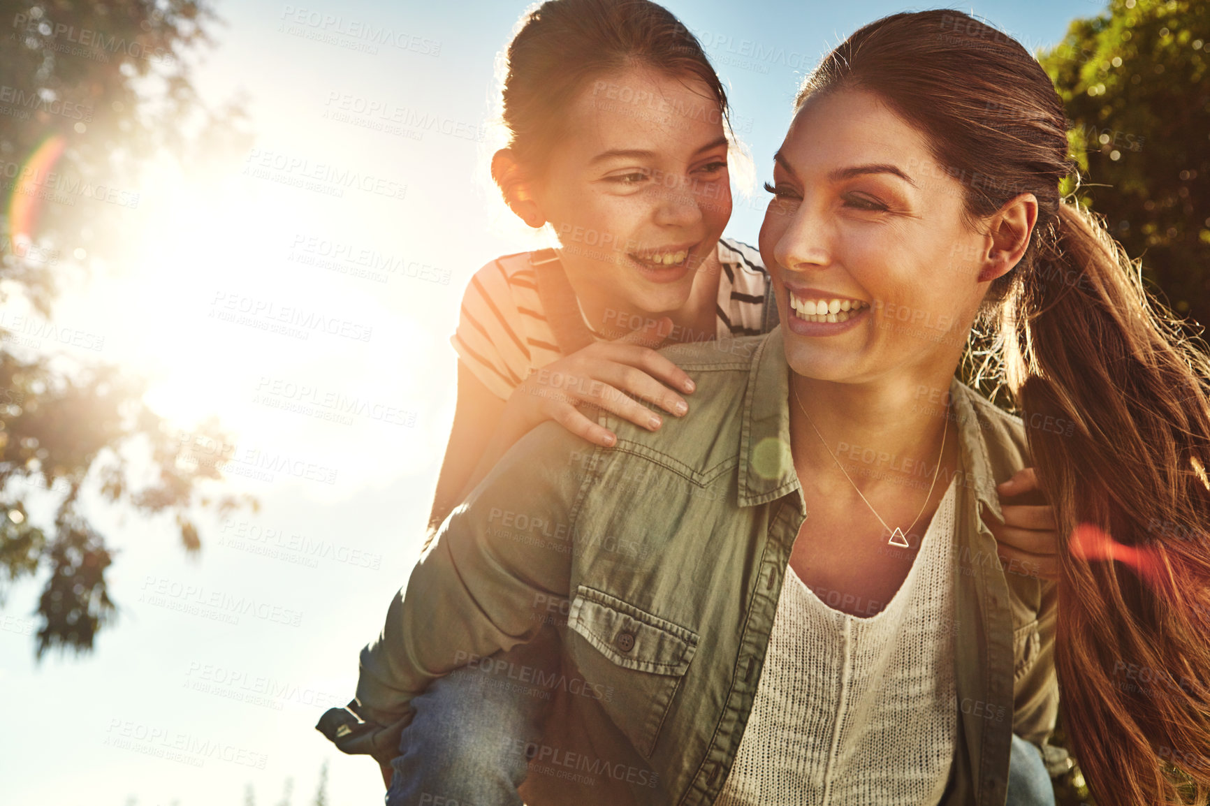 Buy stock photo Piggyback, mom and child with blue sky in outdoor park for game, fun and bonding together. Nature, playing and happy mother with young girl on back for support, summer vacation or weekend in Ohio