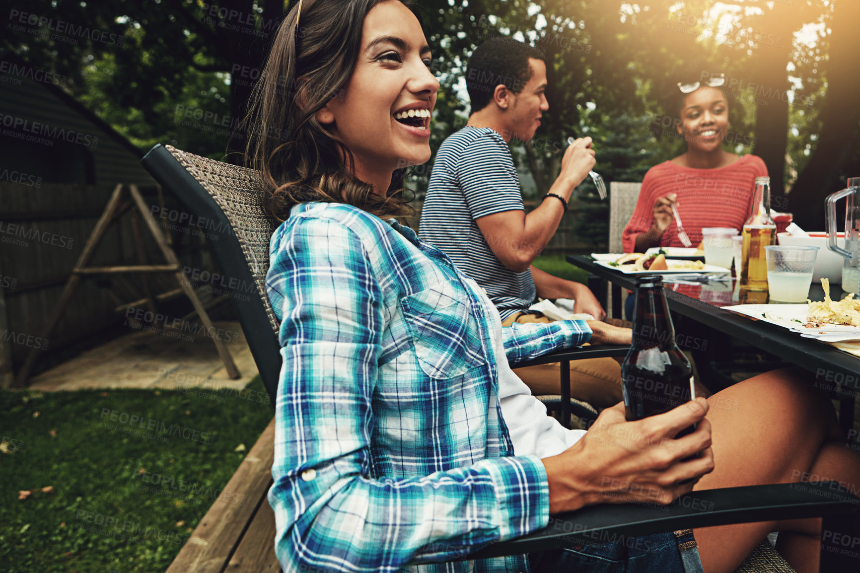 Buy stock photo Outdoor, backyard and woman with friends, laughing and meal for gathering in weekend, break and reunion. Party, people and together with food, enjoy and cooking for celebration, lunch and drinks