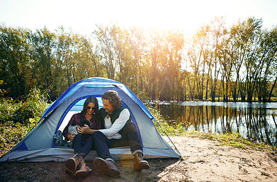 Buy stock photo Shot of an adventurous couple out camping with their dog