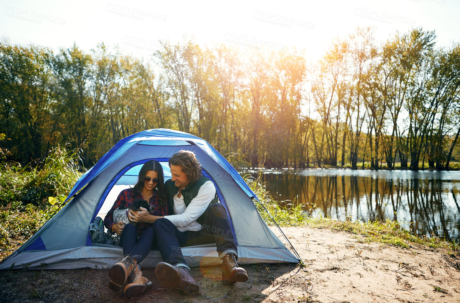 Buy stock photo Shot of an adventurous couple out camping with their dog