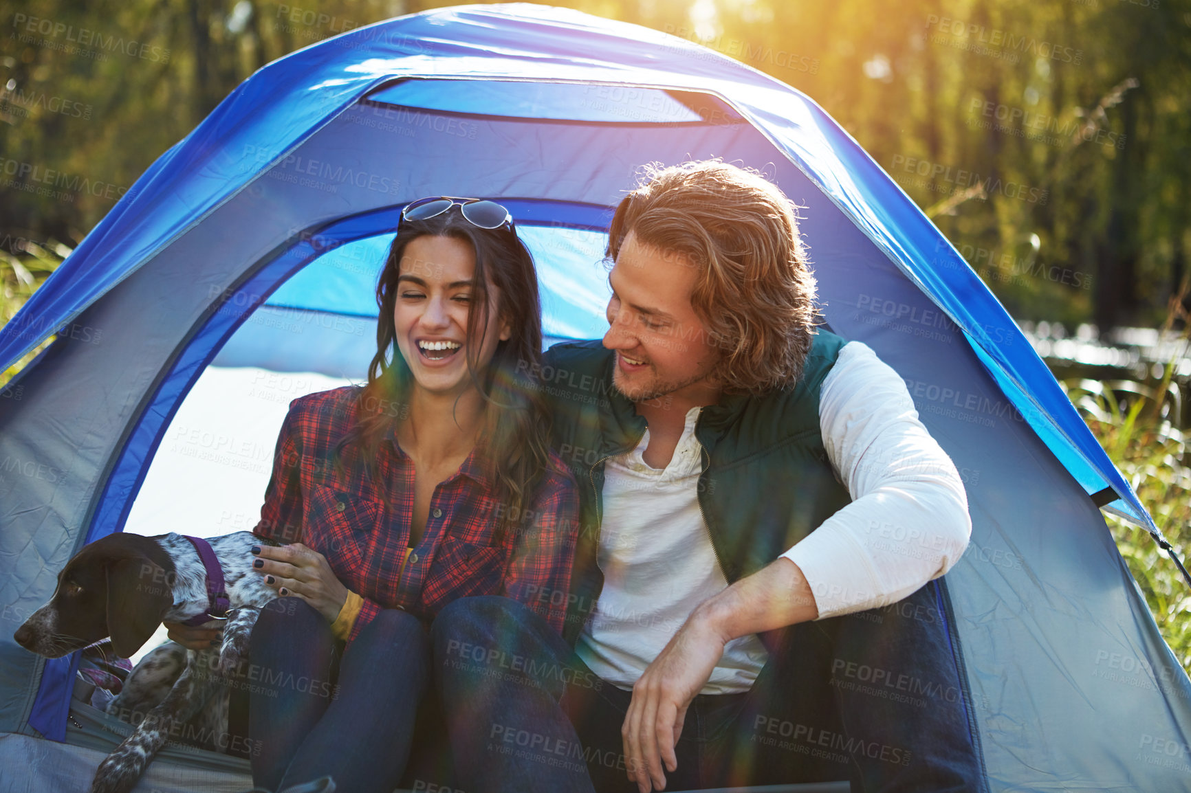 Buy stock photo Shot of an adventurous couple out camping with their dog