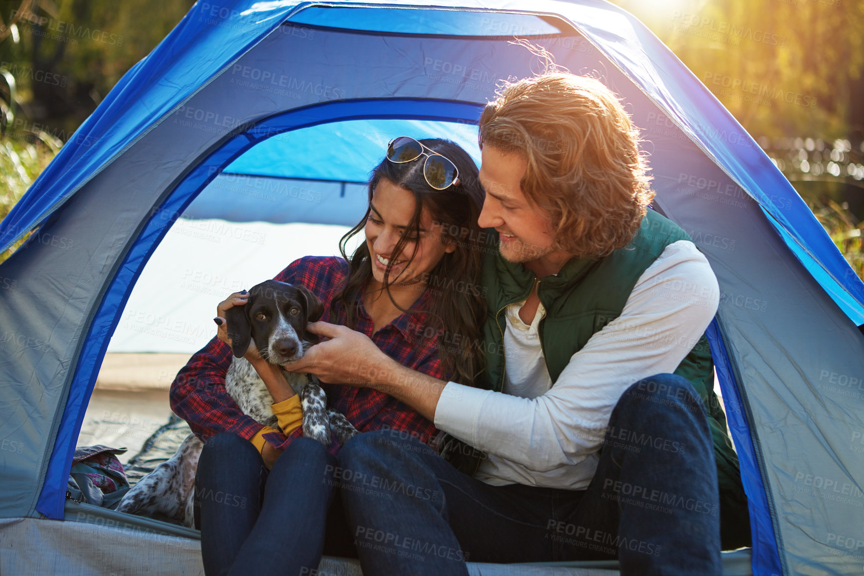 Buy stock photo Shot of an adventurous couple out camping with their dog