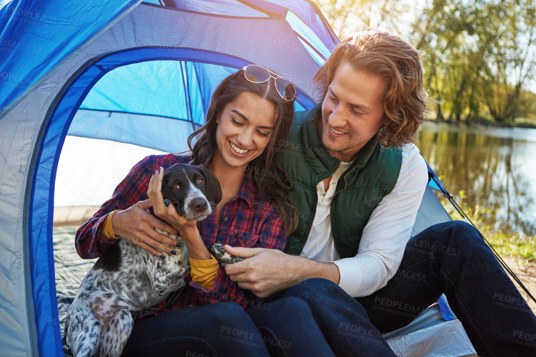 Buy stock photo Shot of an adventurous couple out camping with their dog