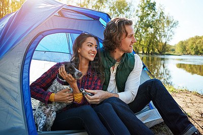 Buy stock photo Shot of an adventurous couple out camping with their dog