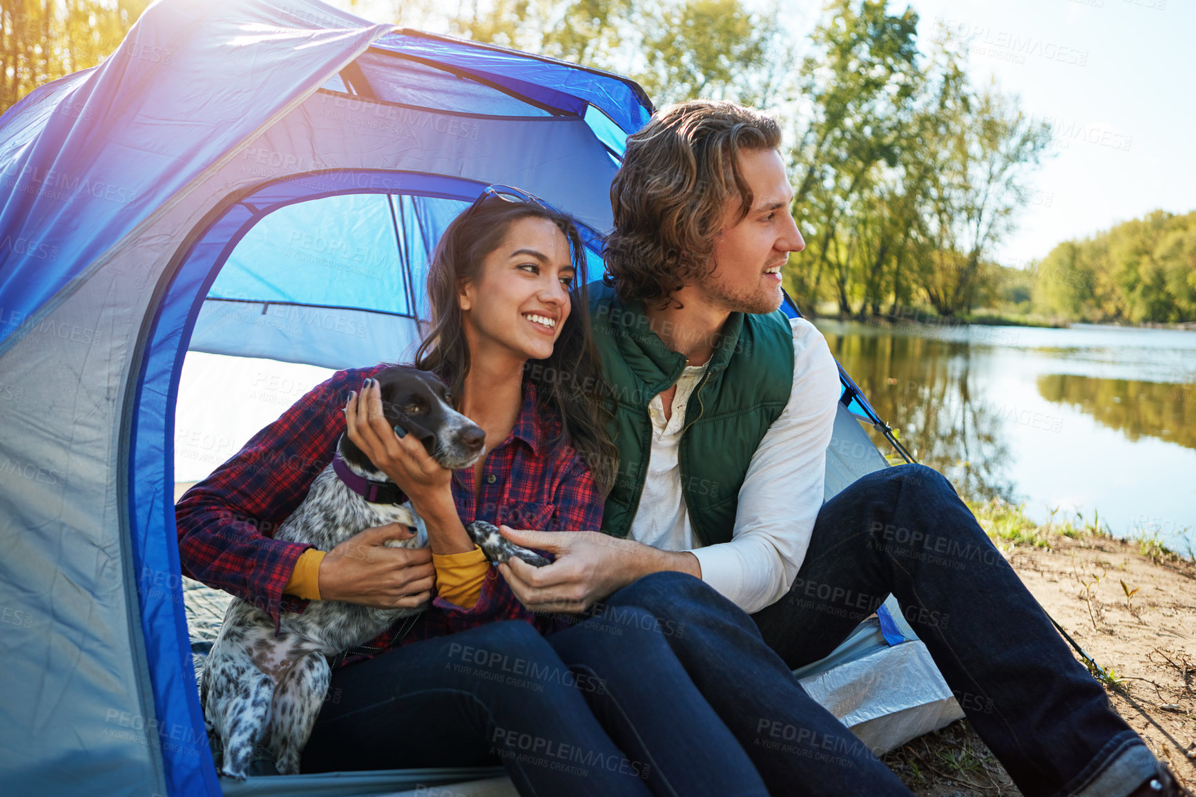 Buy stock photo Shot of an adventurous couple out camping with their dog