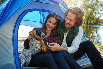 Buy stock photo Shot of an adventurous couple out camping with their dog