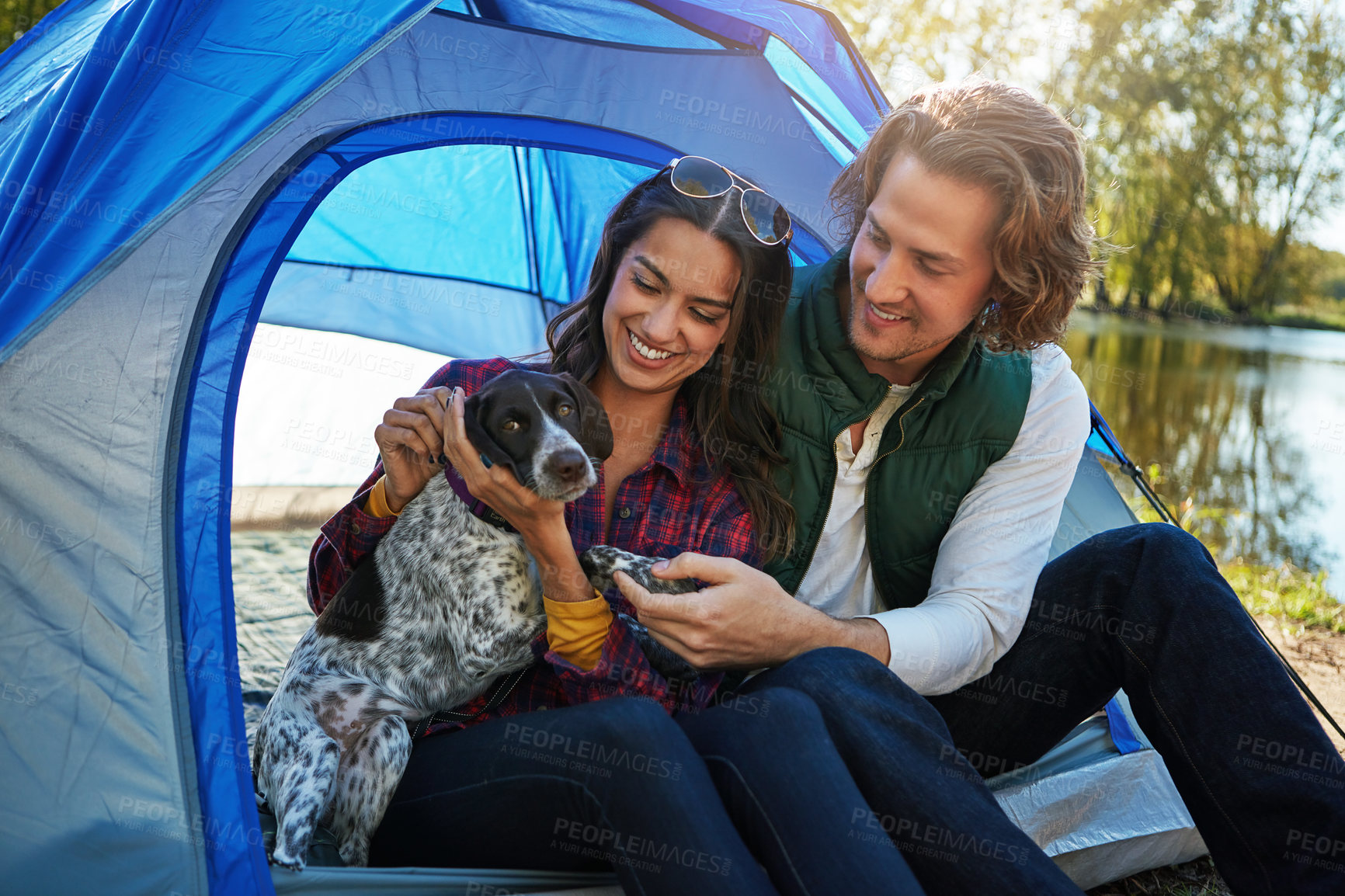 Buy stock photo Shot of an adventurous couple out camping with their dog