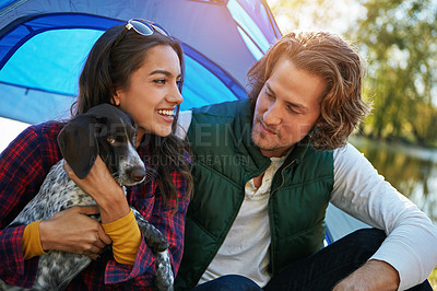 Buy stock photo Shot of an adventurous couple out camping with their dog