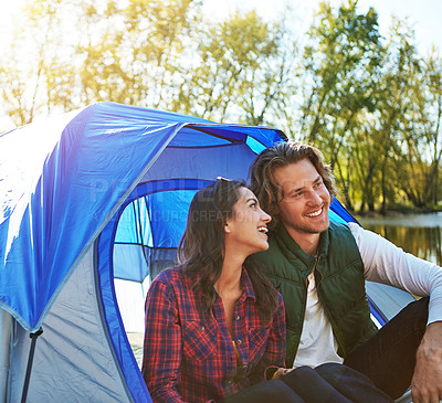 Buy stock photo Camping, vacation and couple in tent relax with love and happiness together on adventure in woods. People, laughing or thinking outdoor in nature or funny chat on holiday, journey or travel in forest