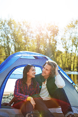 Buy stock photo Camping, chat and couple in tent relax with love and happiness together on adventure in woods. People, embrace or outdoor holiday in nature or travel forest countryside on vacation in summer