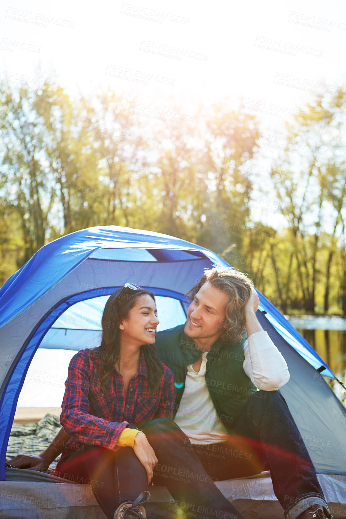 Buy stock photo Camping, chat and couple in tent relax with love and happiness together on adventure in woods. People, embrace or outdoor holiday in nature or travel forest countryside on vacation in summer