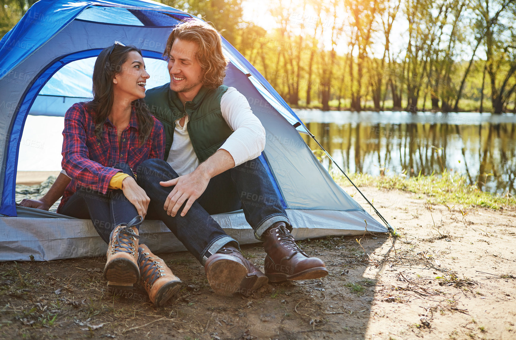 Buy stock photo Shot of an adventurous couple out camping together