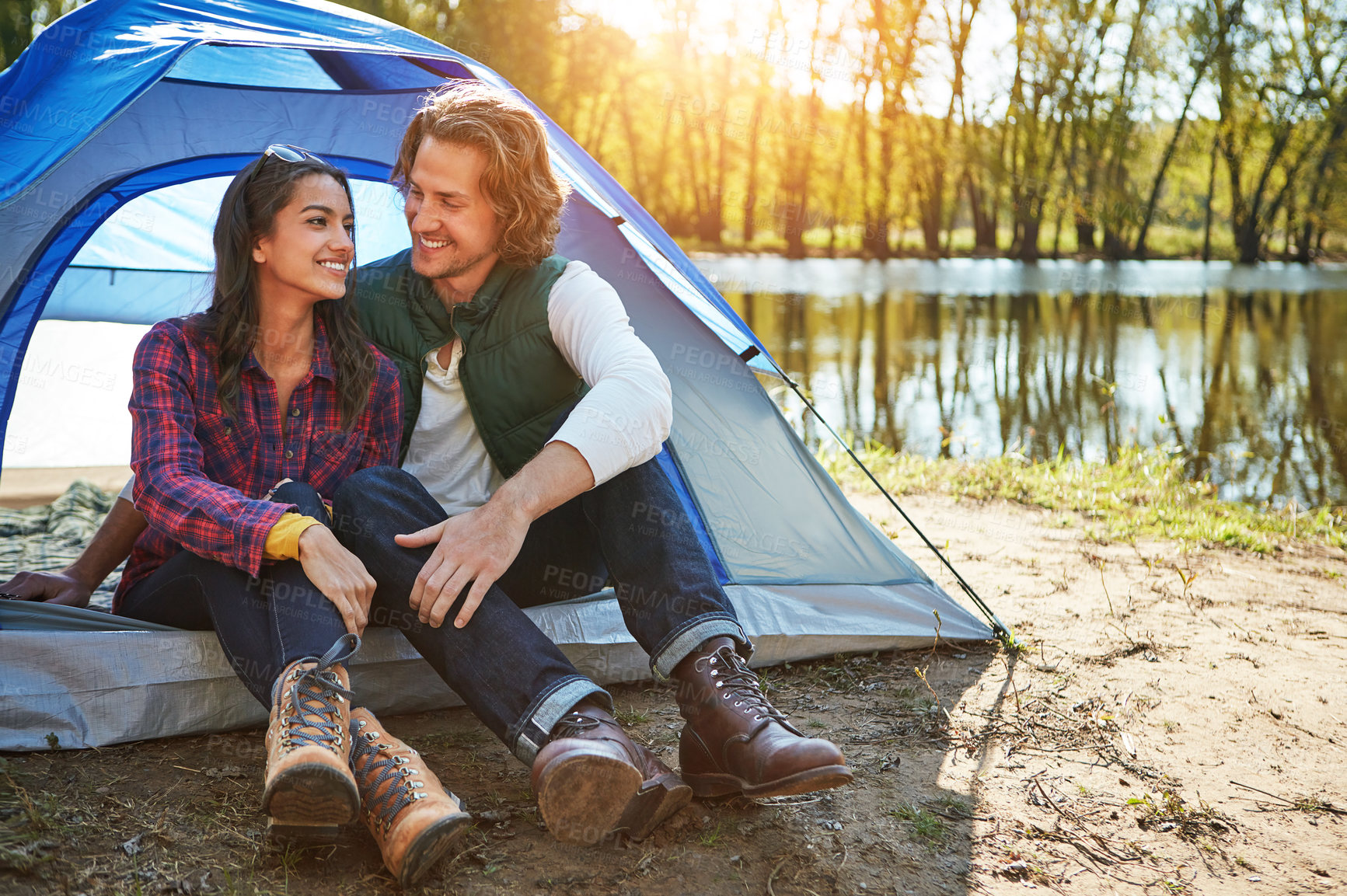 Buy stock photo Shot of an adventurous couple out camping together