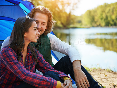 Buy stock photo Camping, couple and relax in tent at river with love and happiness together on adventure in woods. People, embrace or planning outdoor journey in nature on vacation to travel to lake in forest