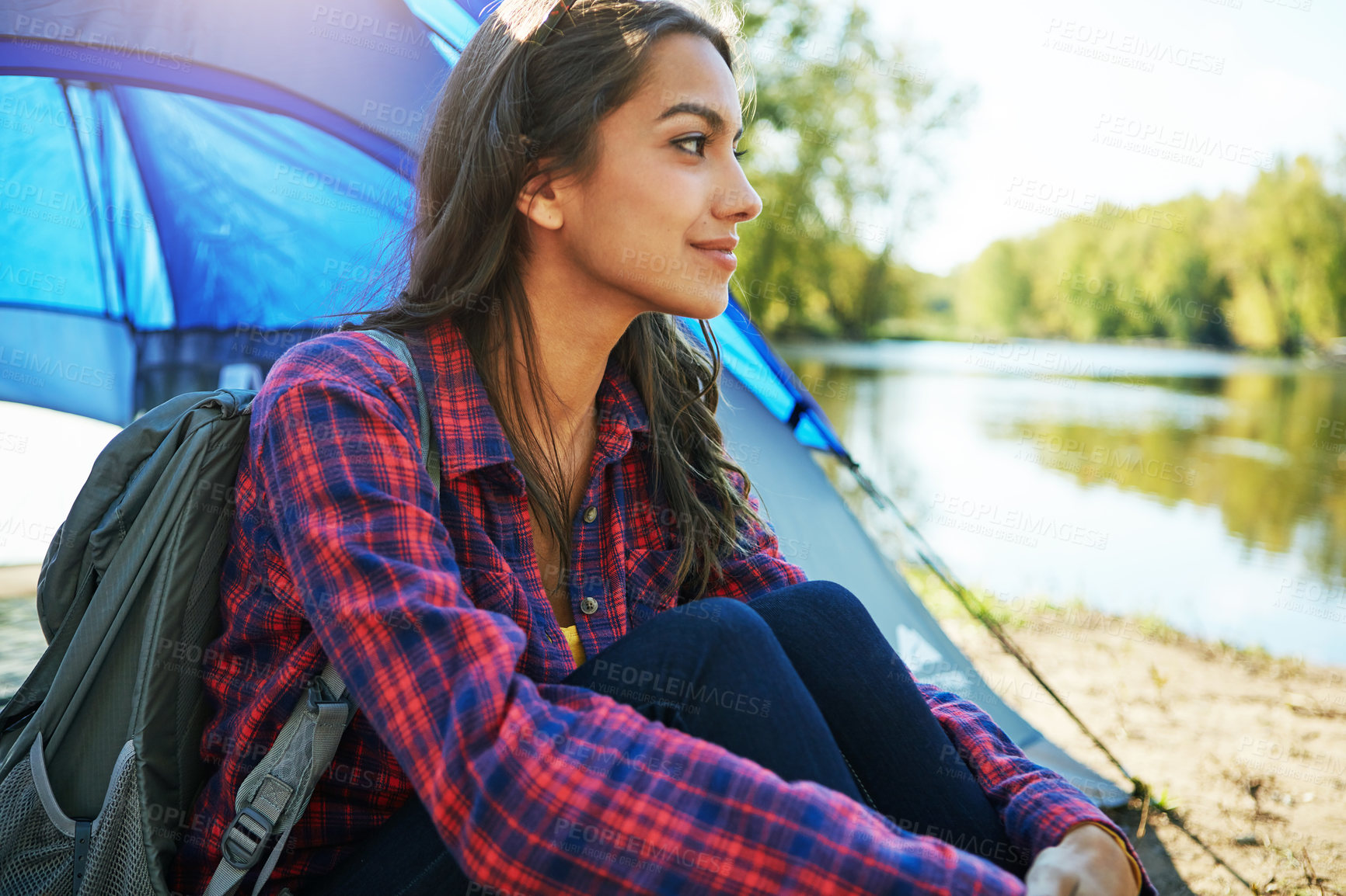 Buy stock photo Cropped shot of an attractive young woman sitting at her campsite