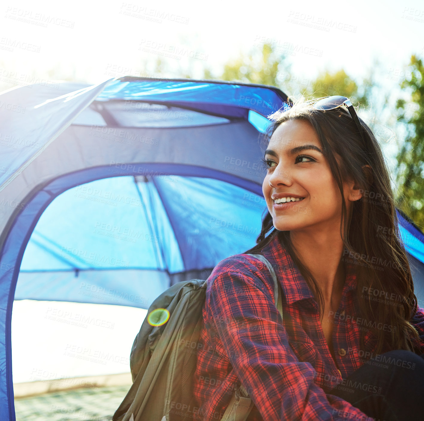 Buy stock photo Cropped shot of an attractive young woman sitting at her campsite