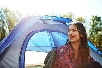 Buy stock photo Cropped shot of an attractive young woman sitting at her campsite