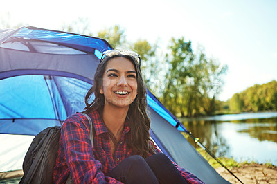 Buy stock photo Cropped shot of an attractive young woman sitting at her campsite