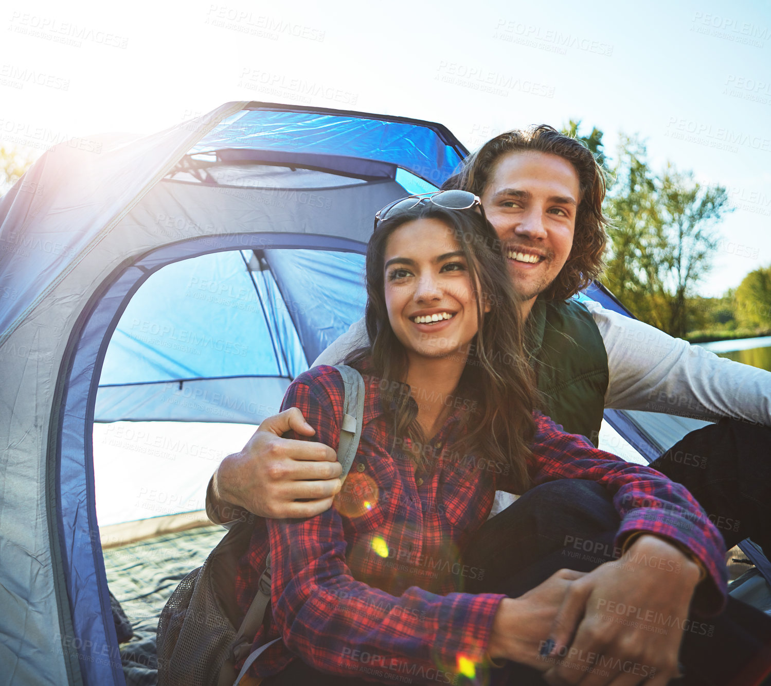 Buy stock photo Shot of an adventurous young couple at their campsite