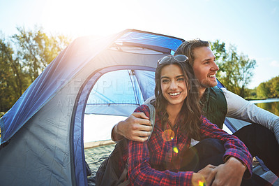 Buy stock photo Shot of an adventurous young couple at their campsite