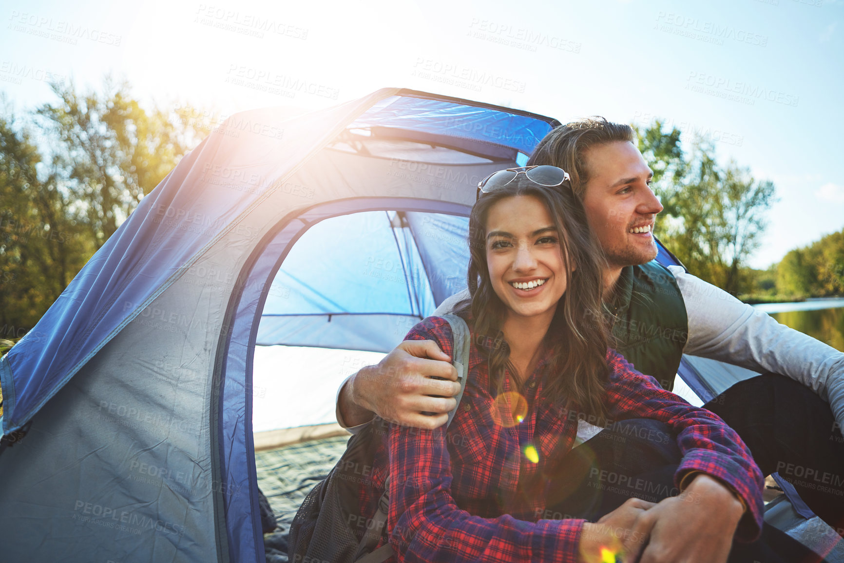 Buy stock photo Shot of an adventurous young couple at their campsite