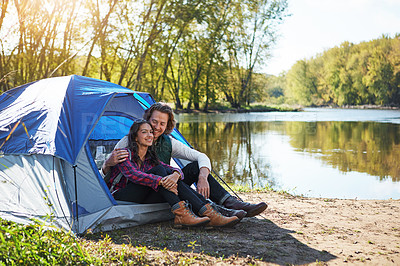 Buy stock photo Shot of an adventurous young couple at their campsite