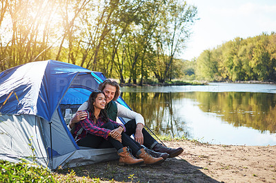 Buy stock photo Shot of an adventurous young couple at their campsite