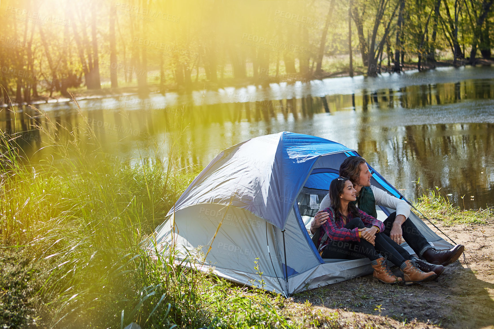 Buy stock photo Shot of an adventurous young couple at their campsite