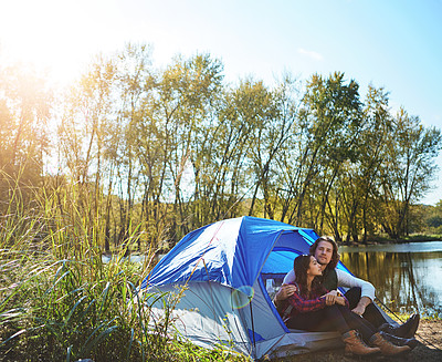 Buy stock photo Shot of an adventurous young couple at their campsite