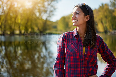 Buy stock photo Cropped shot of an attractive young woman sitting at her campsite