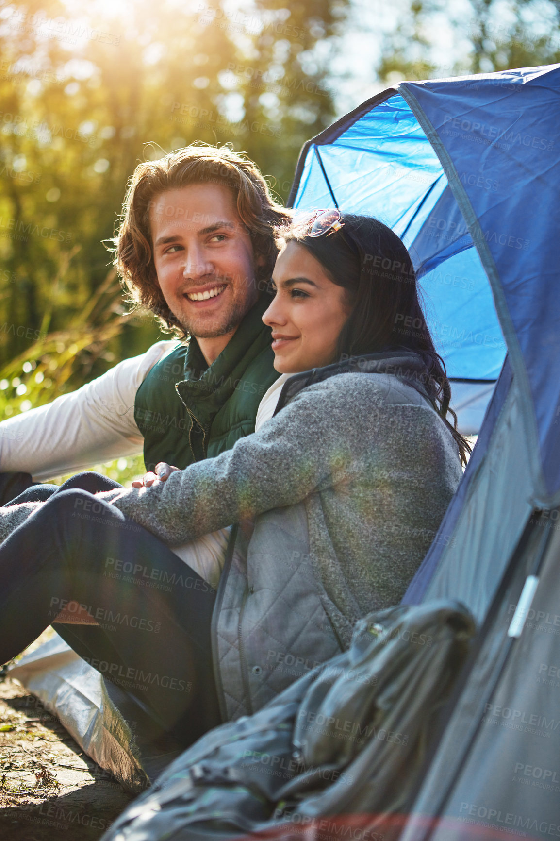 Buy stock photo Shot of an adventurous young couple at their campsite