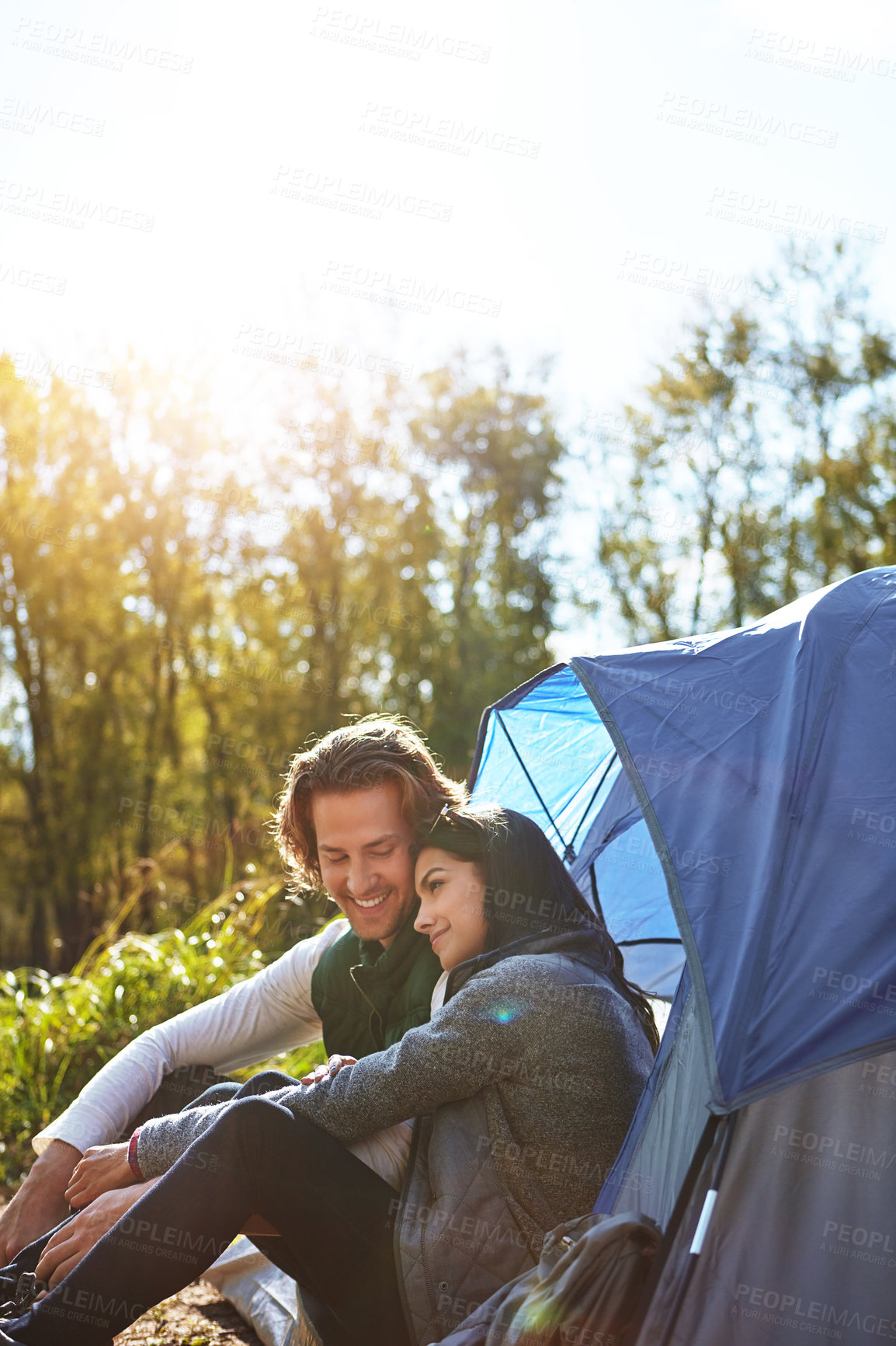 Buy stock photo Shot of an adventurous young couple at their campsite