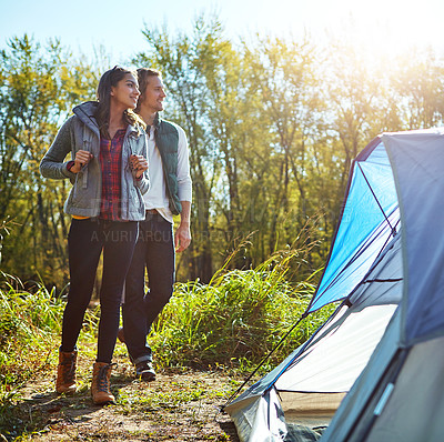 Buy stock photo Shot of an adventurous young couple at their campsite