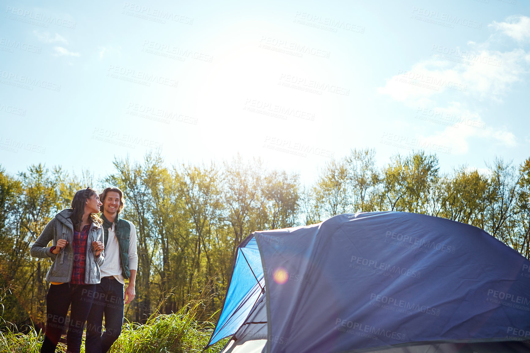 Buy stock photo Shot of an adventurous young couple at their campsite