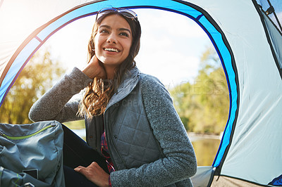 Buy stock photo Cropped shot of an attractive young woman sitting at her campsite