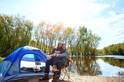 Buy stock photo Shot of an adventurous young couple at their campsite