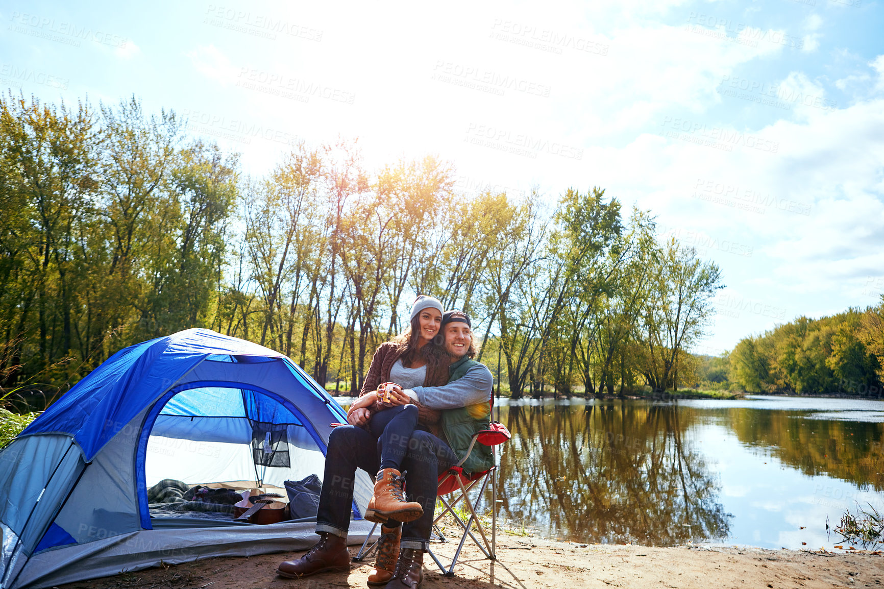 Buy stock photo Shot of an adventurous young couple at their campsite