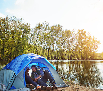 Buy stock photo Shot of an adventurous young couple at their campsite