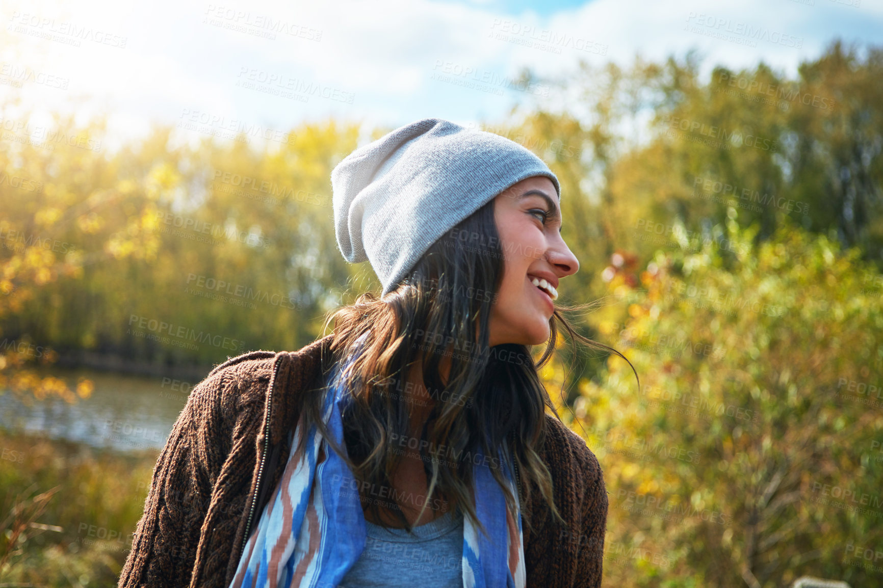 Buy stock photo Shot of a young woman enjoying a day outdoors